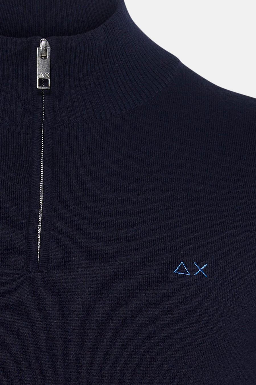 Navy blue ribbed turtleneck sweater with silver zipper and small embroidered logo on chest, close-up front view