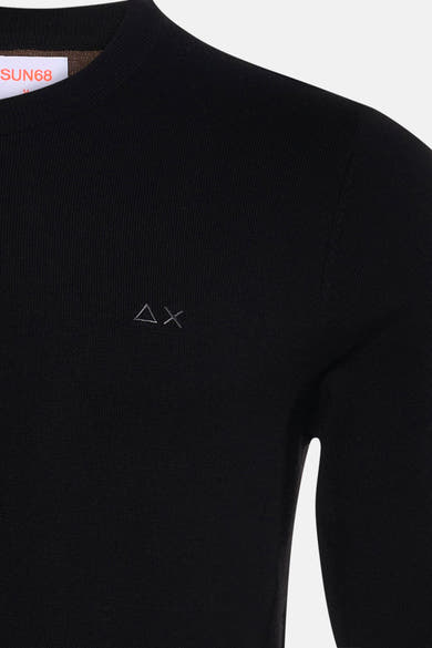 Black ribbed crewneck sweater by SUN68 with small silver triangle and cross embroidery on chest, close-up front view