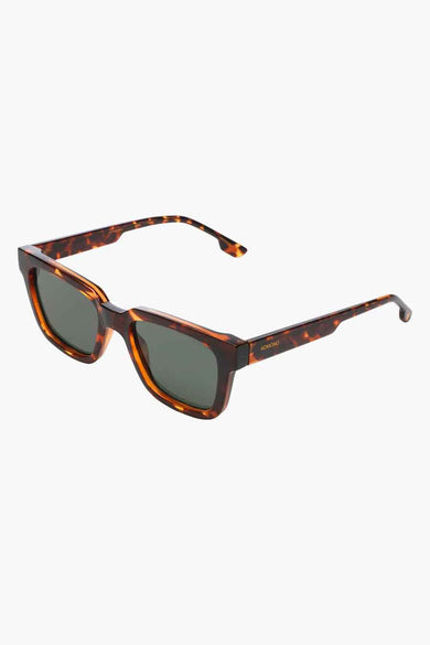 Lunettes de soleil marron de KOMONO, avec une monture effet écaille de tortue.
