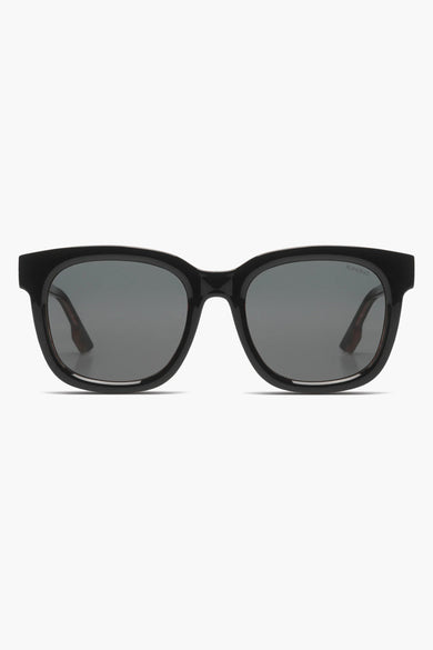 Lunettes de soleil noires de KOMONO, monture carrée, verres fumés.