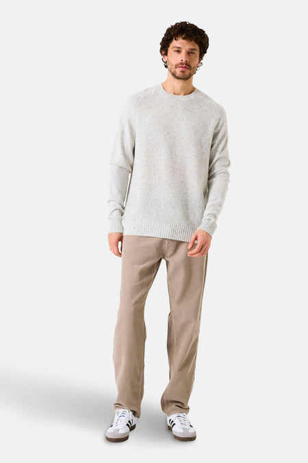 Pull col rond écru de GARCIA, porté avec un pantalon en velours côtelé et des baskets blanches.