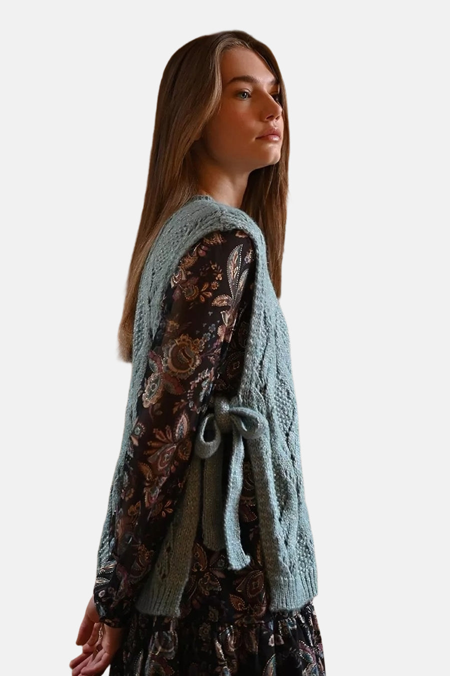 Blauwe tanktop van Molly Bracken, gedragen over een jurk met bloemenprint en aan de zijkant geknoopt.