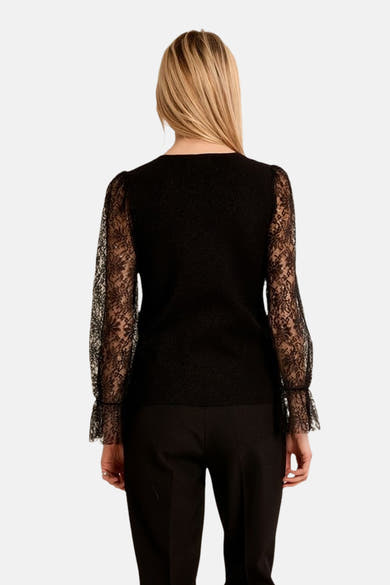Black round-neck sweater with lace sleeves by Molly Bracken, back view, textured knit body, flared cuffs, model wearing black trousers