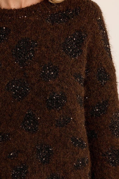 Brown fuzzy O-neck sweater with black sequined floral pattern, close-up front view