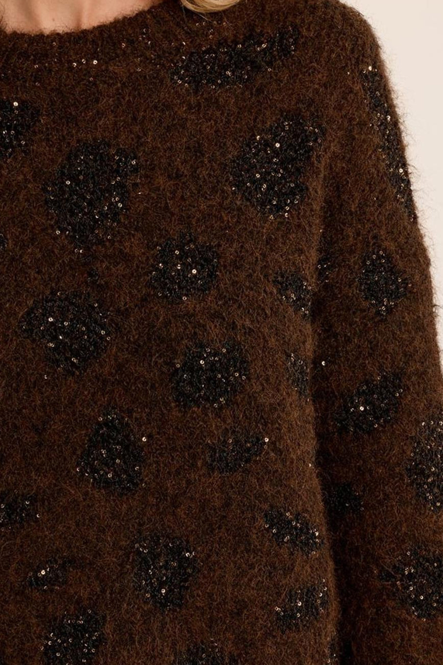 Brown fuzzy O-neck sweater with black sequined floral pattern, close-up front view