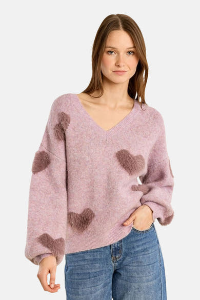 Lavender oversized V-neck sweater with brown heart appliqués, soft fuzzy texture, worn with blue jeans, front view