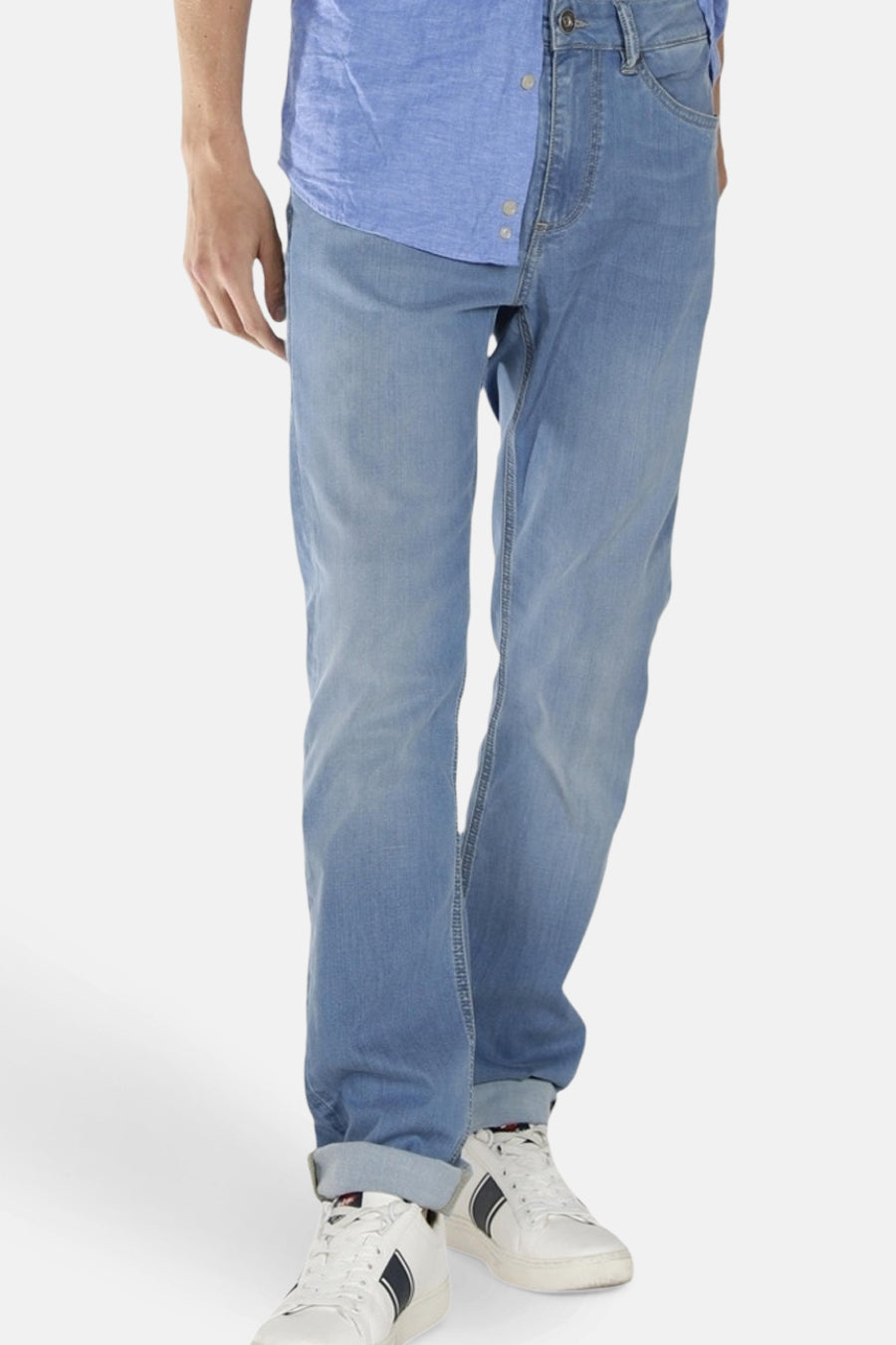 Rechte lichtblauwe spijkerbroek van Lee Cooper, gedragen met een blauw overhemd en witte sneakers.
