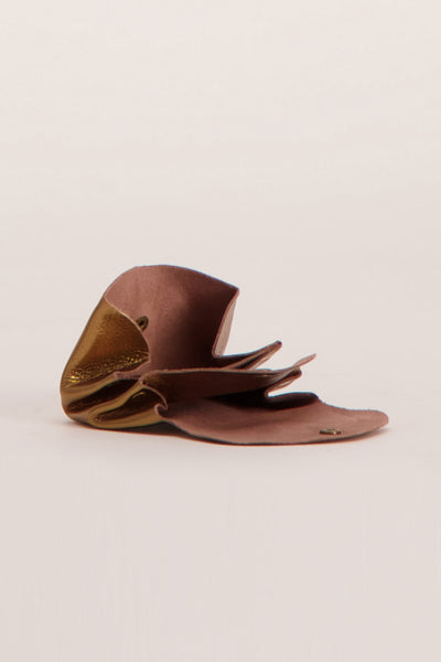 Brown leather handbag by PAUL MARIUS with gold metallic accent and layered flap design, side view