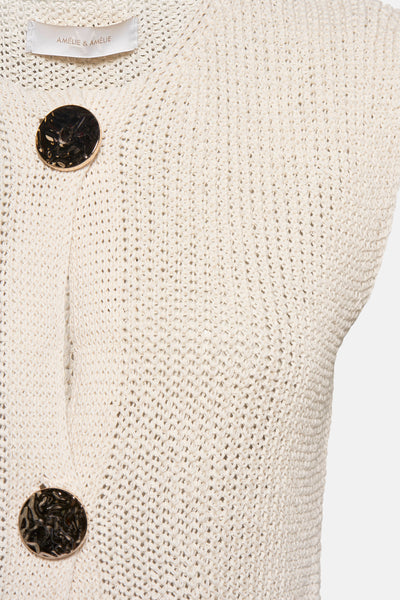Beige vest in openwork knit by AMELIE ET AMELIE, with decorative gold buttons, on a white background.