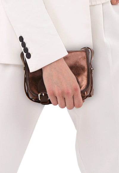 Brown leather handbag with metallic sheen and silver buckle, held by model in white suit, side view