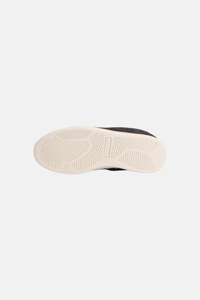 Green suede sneakers by Baskets, bottom view showing white rubber sole with textured tread pattern
