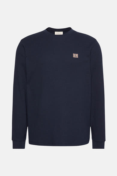 Blauwe T-shirt met lange mouwen van Calvin Klein Jeans, met wafelstructuur en vierkant logo op de borst.
