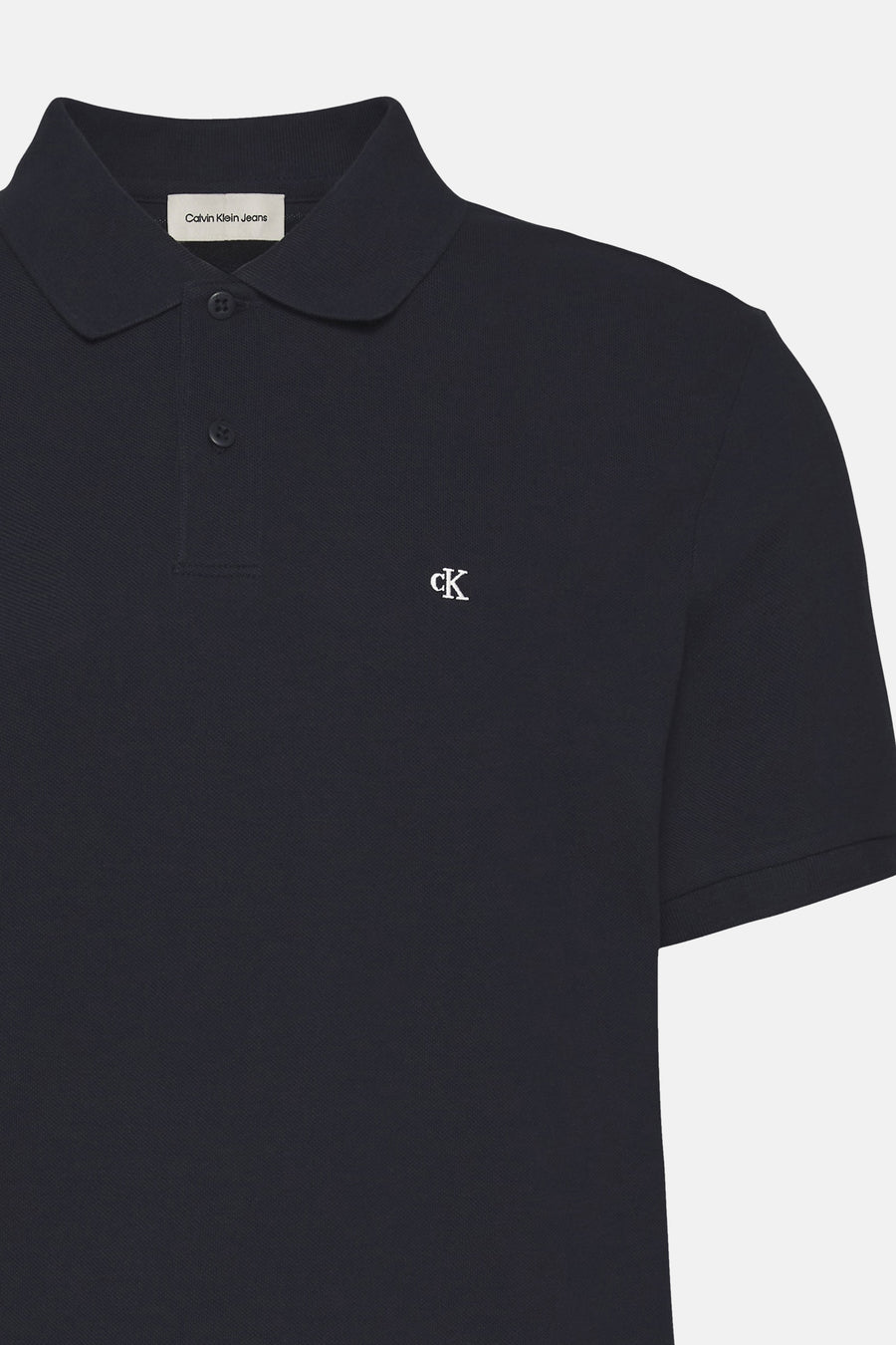 Polo bleu marine en maille piquée de Calvin Klein, avec logo « ck » blanc brodé.