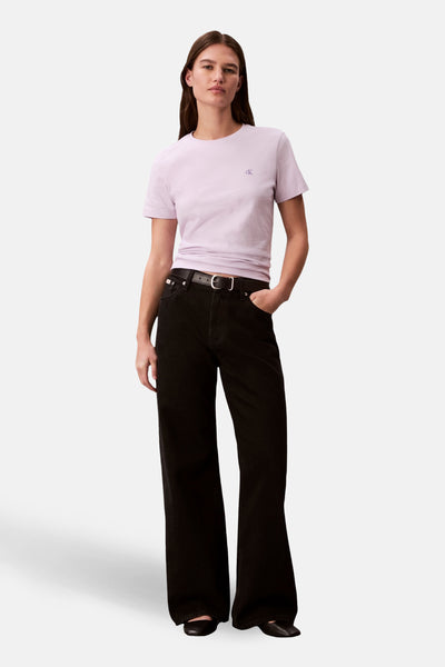 T-shirt mauve à manches courtes de Calvin Klein, porté avec un jean noir taille haute et une ceinture noire.