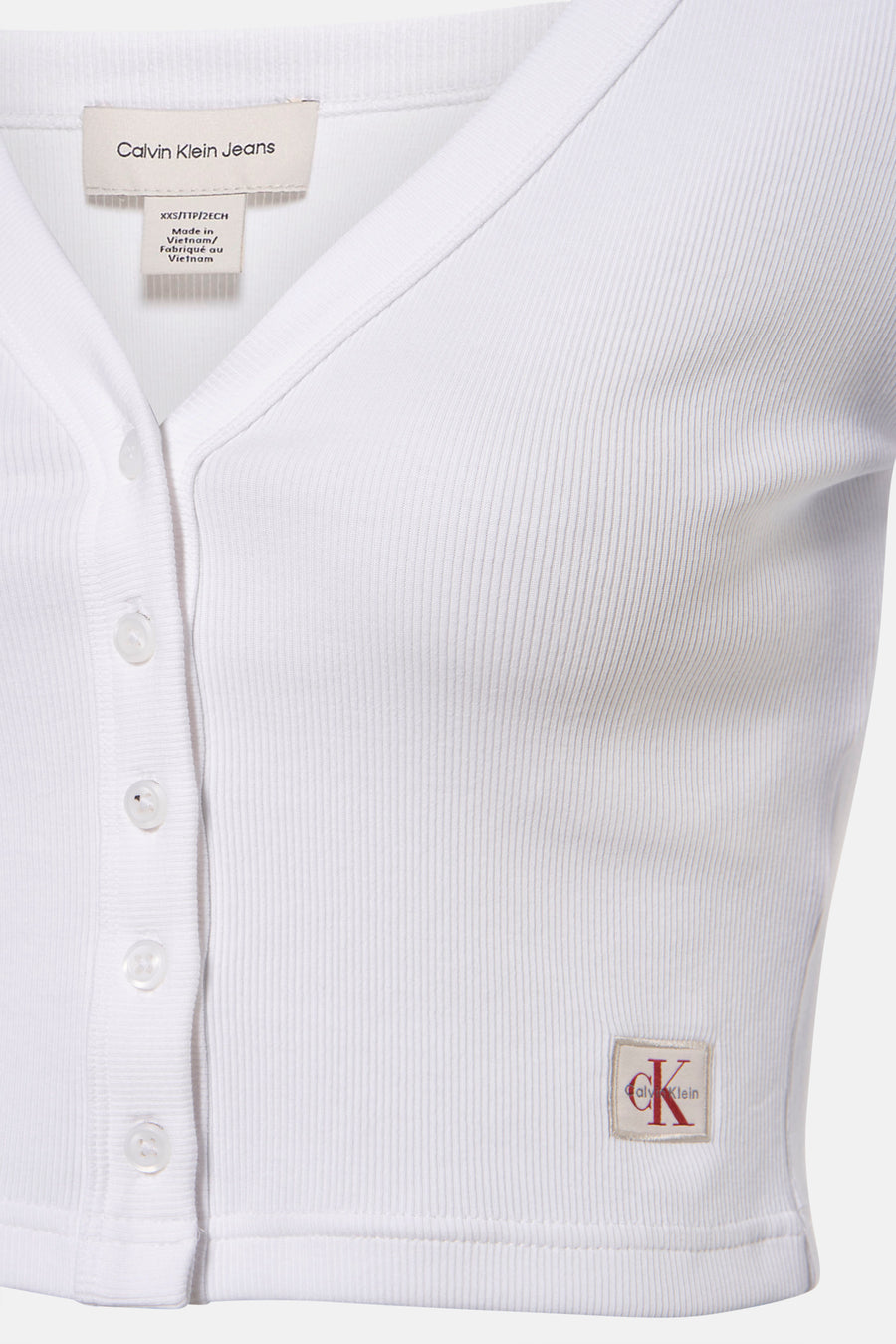 Wit T-shirt met lange mouwen van Calvin Klein, in geribbelde stof met knoopsluiting en discreet logo.