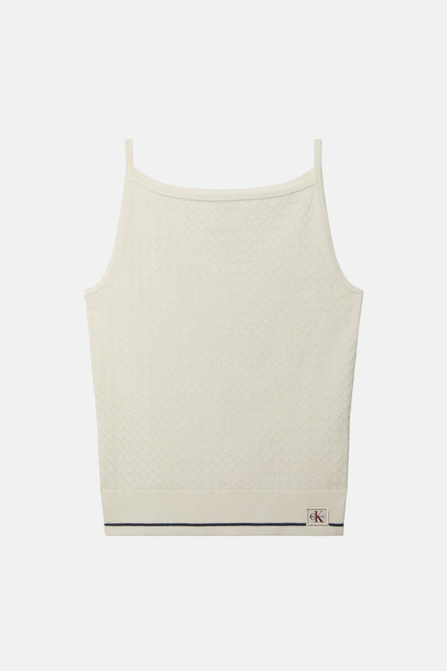Top écru sans manches de Calvin Klein, motif texturé en losange, bande marine et logo CK sur le bas.
