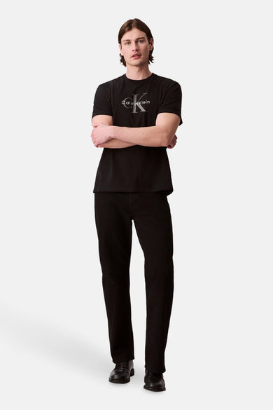 Zwart T-shirt met korte mouwen van Calvin Klein, gedragen met een zwarte jeans en leren schoenen.