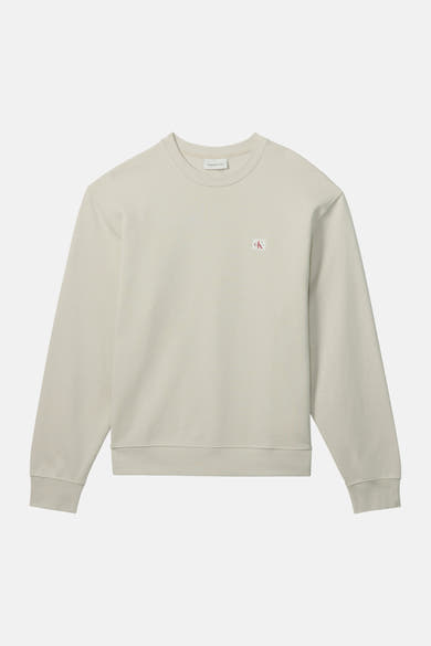 Sweat-shirt beige en coton, de Calvin Klein, avec un logo discret sur la poitrine.
