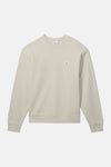 Sweat-shirt beige en coton, de Calvin Klein, avec un logo discret sur la poitrine.
