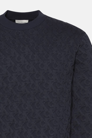 Sweat bleu en maille jacquard de Calvin Klein Jeans, avec un motif monogramme en relief sur l'ensemble.