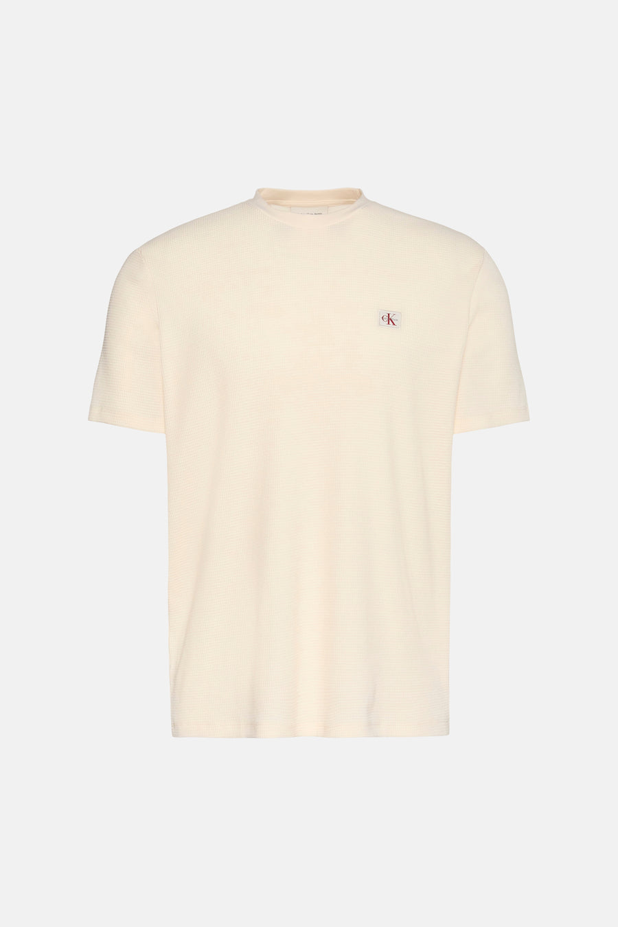 T-shirt à manches courtes jaune van Calvin Klein avec un motif texturé gaufré.