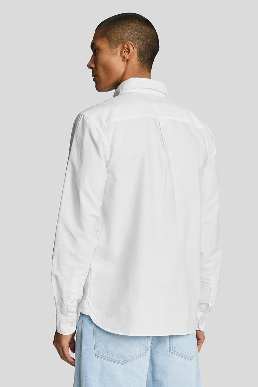 Chemise blanche à manches longues de LYLE & SCOTT, vue de dos, portée avec un jean bleu clair.