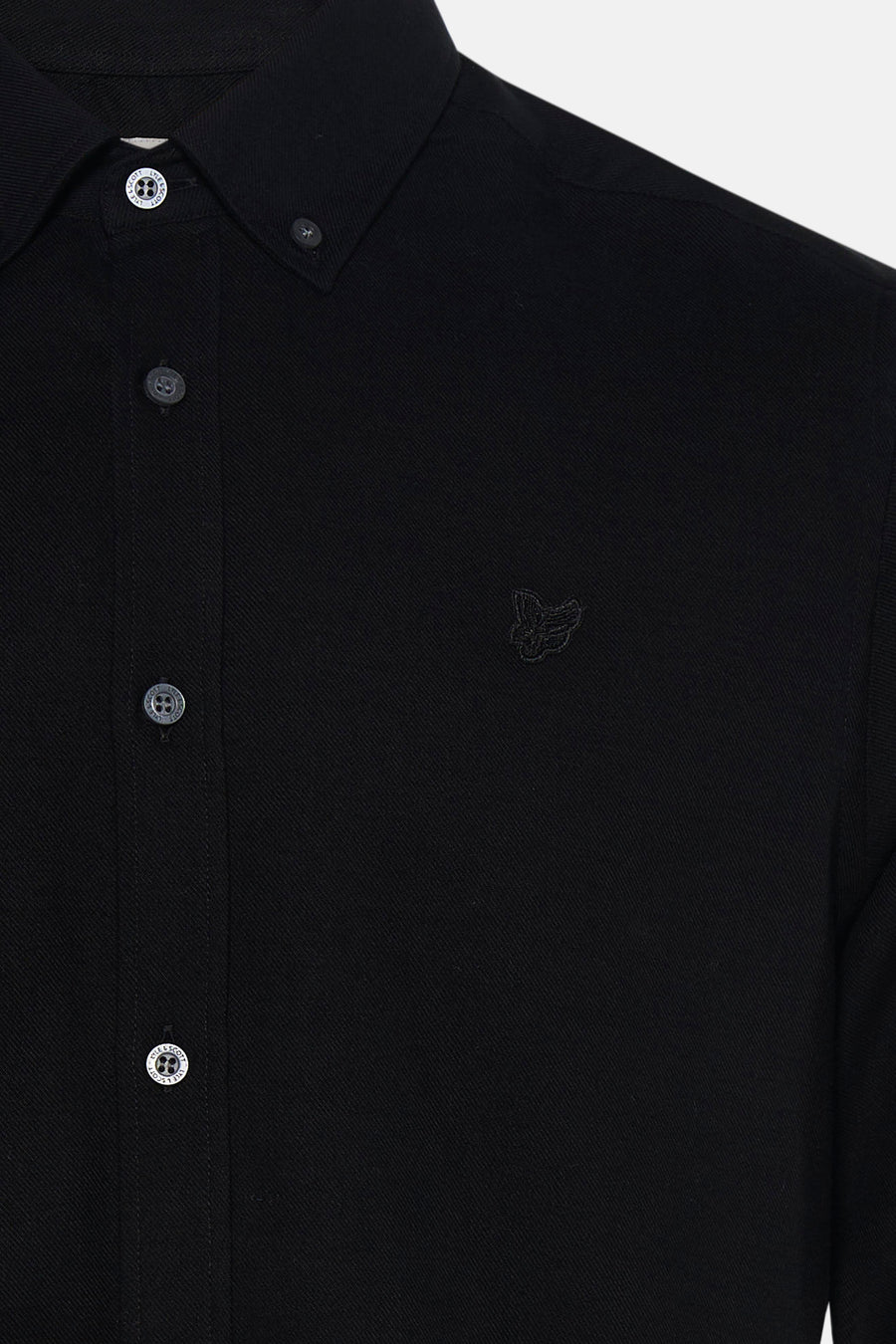 Black long-sleeve shirt with textured fabric and subtle butterfly embroidery, featuring branded buttons, close-up front view
