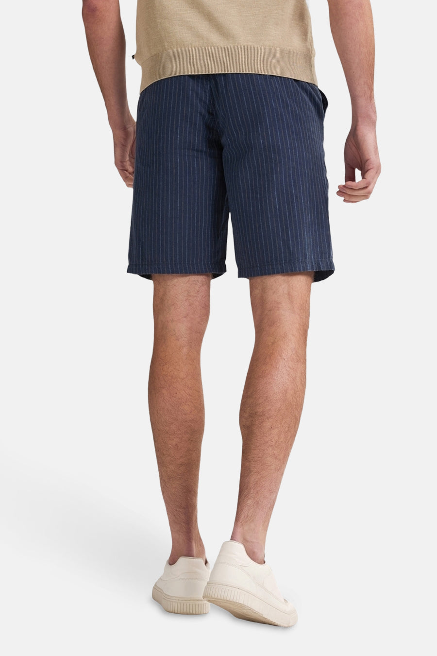 Short bleu à rayures verticales par Petrol Industries, porté avec un haut beige et des baskets crème, vue de dos.
