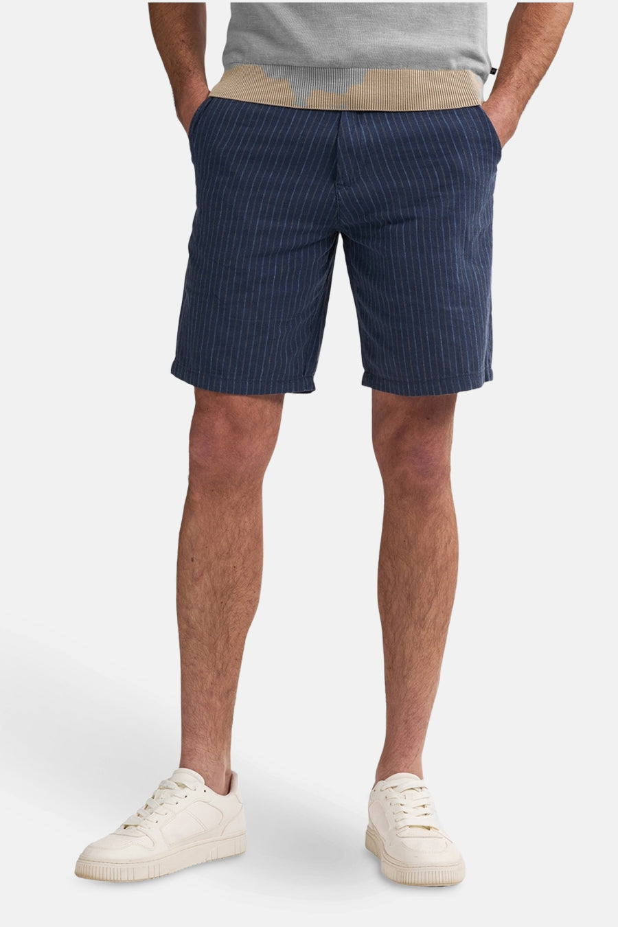 Short bleu à rayures by Petrol Industries, porté avec un t-shirt gris et des baskets blanches.