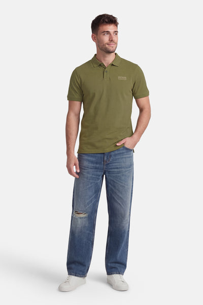 Polo à manches courtes vert de Petrol Industries®, porté avec un jean et des baskets blanches.