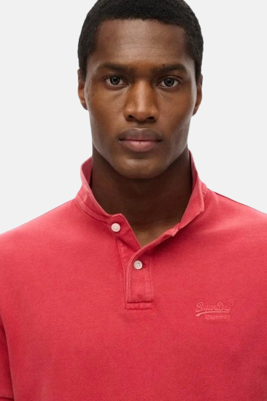 Polo rouge à manches courtes de Superdry, avec col boutonné et logo brodé discret.
