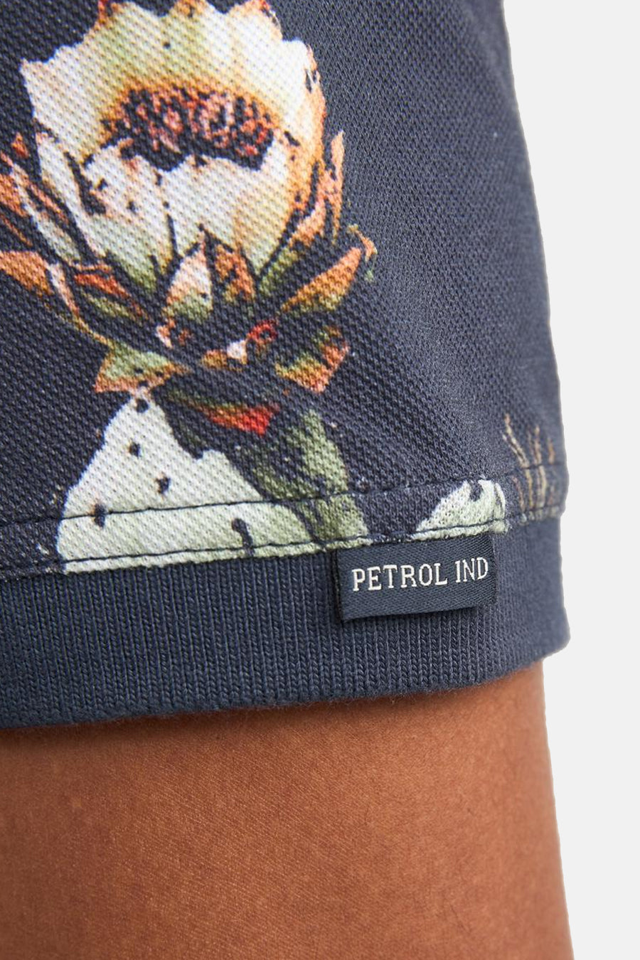Multikleurig poloshirt van Petrol Industries met cactusbloemenpatroon op donkergrijs pique-stof met merklabel.