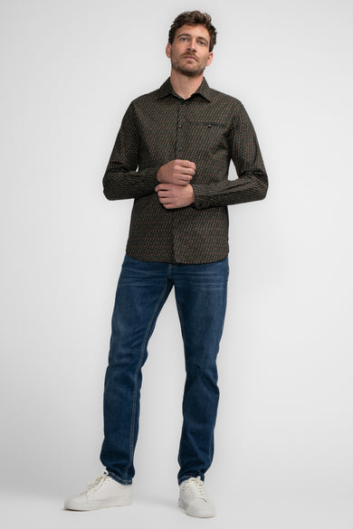Chemise noire à manches longues de Petrol Industries, à motif géométrique, portée avec un jean bleu et des baskets blanches.