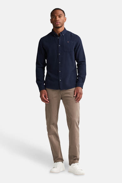 Blauw overhemd met lange mouwen van Petrol Industries, met borstzak en zichtbare knopen, gedragen met een bruine broek.