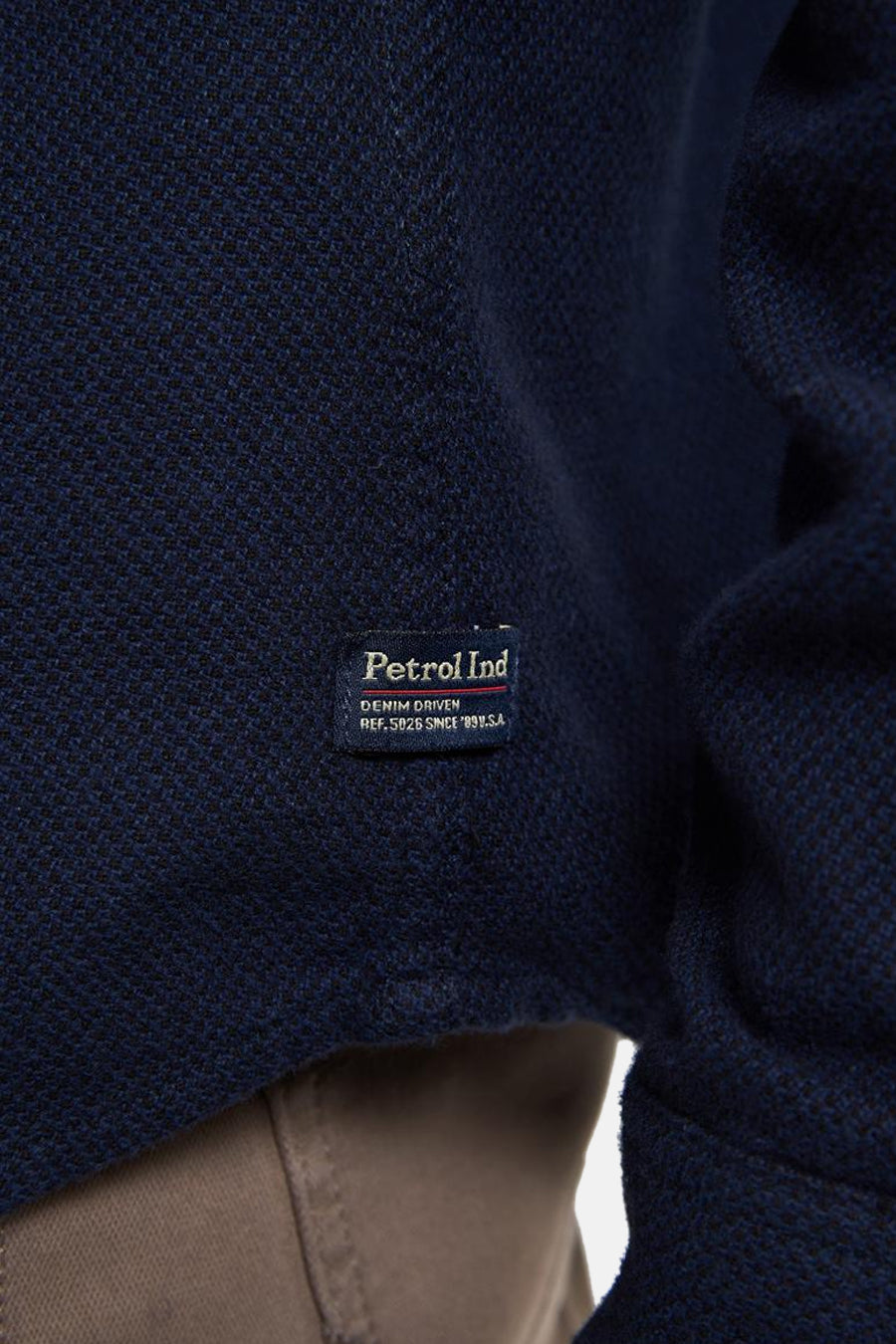 Blauwe longsleeve polo van piquébreiwerk van Petrol Industries, met geweven label aan de voorkant.