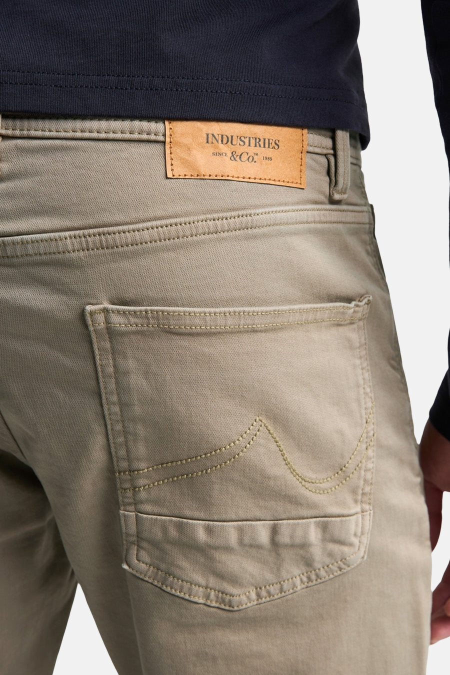 Khaki men's 5-pocket seasonal pants by Petrol Industries, back view with leather brand patch and stitched pocket detail