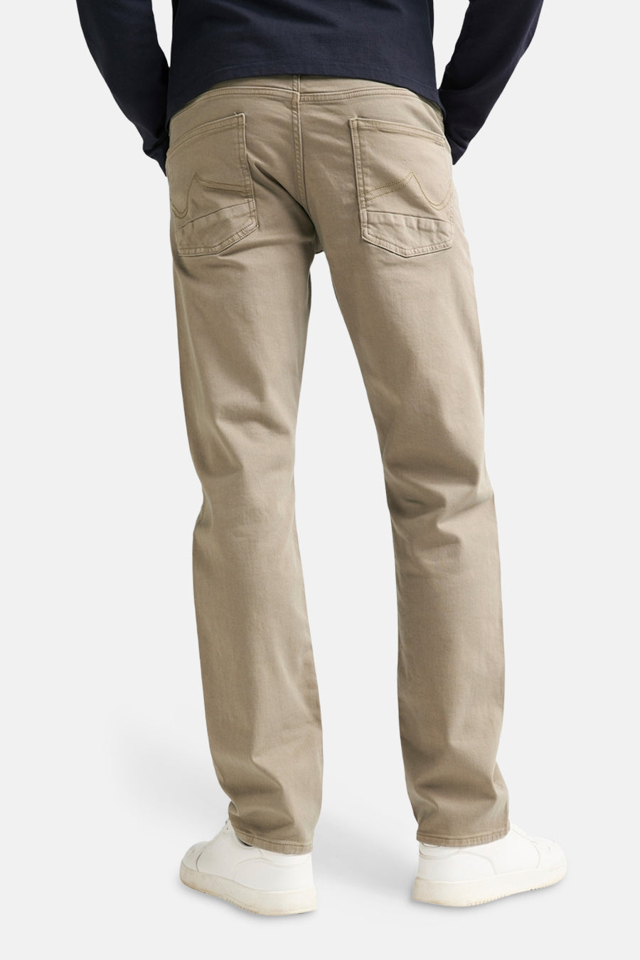 Khaki men's 5-pocket seasonal pants by Petrol Industries, back view, featuring two rear pockets with stitching detail, worn with dark long-sleeve top and white sneakers