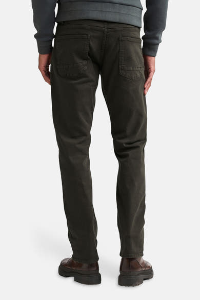 Brown five-pocket seasonal men's trousers by Petrol Industries, back view, slim fit with visible stitching and dark brown leather shoes.