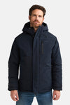 Long black puffer coat with hood and front zipper by Petrol Industries, worn with blue jeans, front view