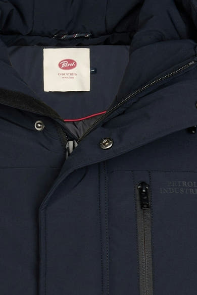 Navy long coat by Petrol Industries with front zipper, silver buttons, and brand label visible inside collar