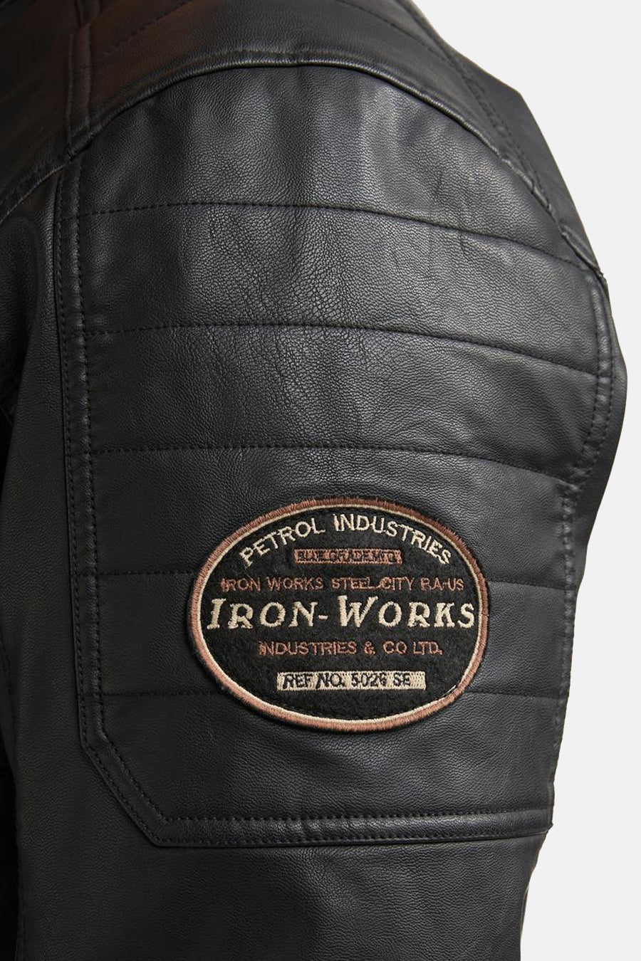 Black denim vest with quilted shoulder panel and oval Iron-Works patch, side view close-up