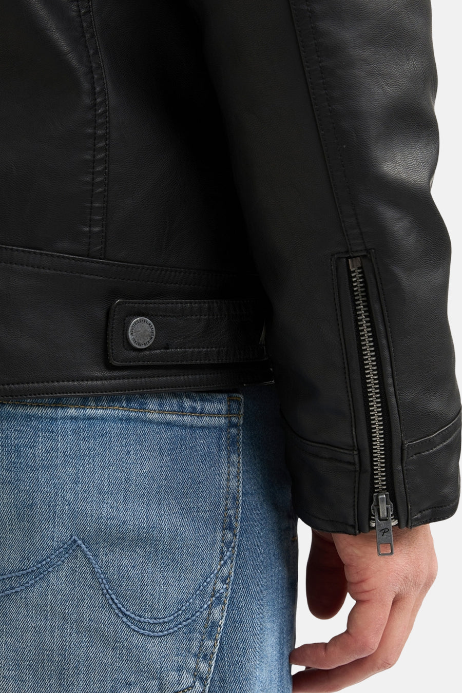 Black denim vest with side zipper and belt detail, worn with blue jeans, close-up side view