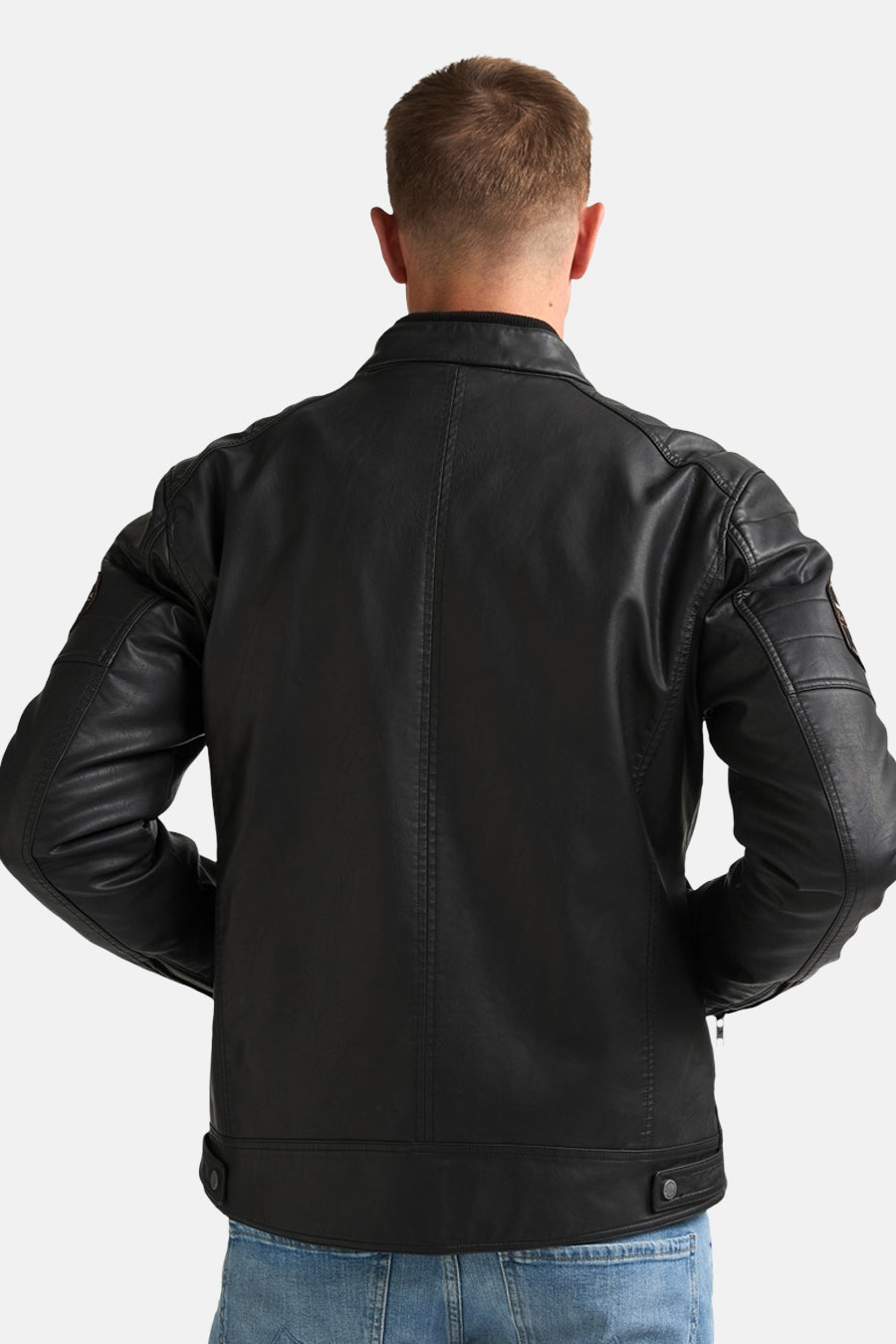 Black denim vest back view with stitched seams and side snap tabs, worn with blue jeans