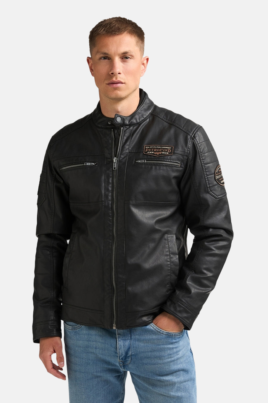Black denim vest by Petrolind, front view with zip closure, chest pockets, and brand patches, worn with blue jeans.