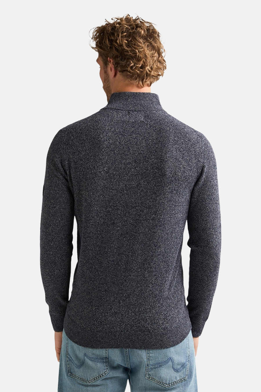 Blue marled turtleneck sweater back view, ribbed cuffs and hem, worn with light blue jeans