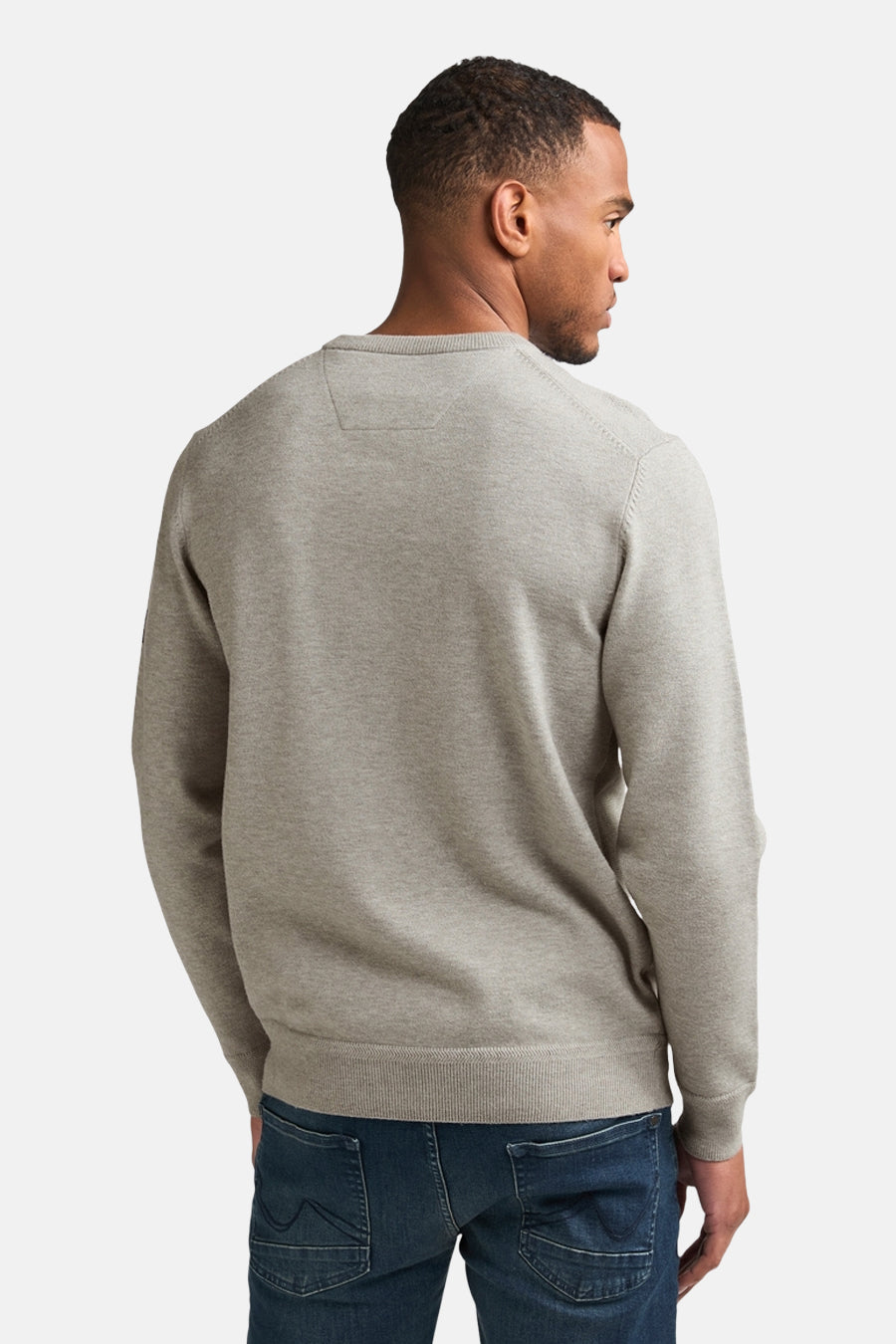 Grey crewneck sweater with ribbed cuffs and hem, back view on model wearing dark jeans