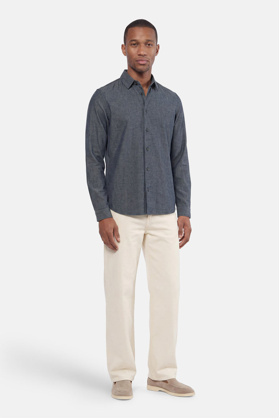 Blue long-sleeve shirt with textured fabric, button-down front, and classic collar, worn with cream pants and tan loafers in full-length front view.