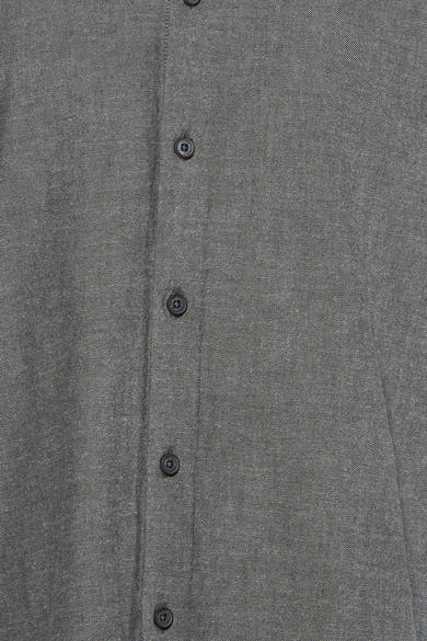 Green long-sleeve shirt with textured fabric and dark buttons, front close-up view