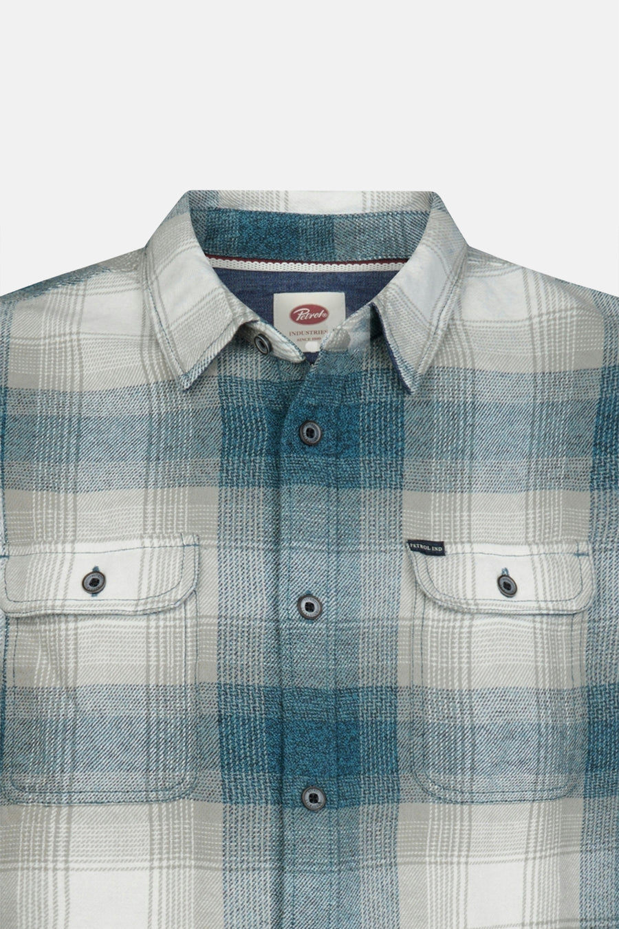 Blue and white plaid long-sleeve shirt by Petrol Industries, featuring two chest pockets with button flaps and a classic collar, front view.