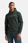 Dark green hooded sweatshirt with front pocket and gold script logo, worn by model in lifestyle front view